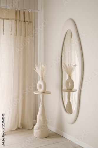 Beautiful light beige interior with curved mirror in wooden frame in japandi and wawabi sabi style, cozy home concept