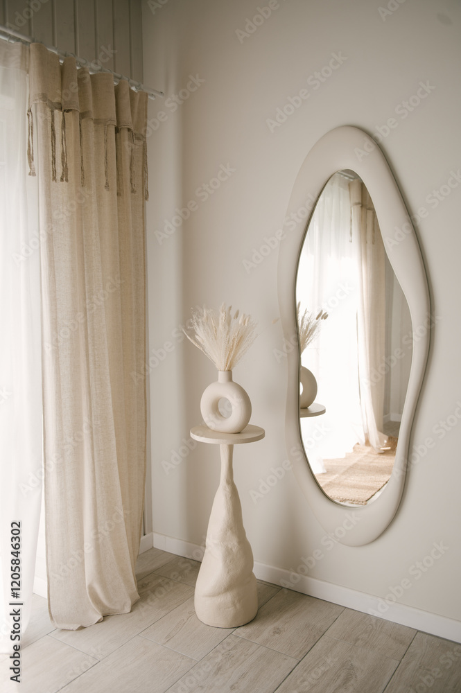 Beautiful light beige interior with curved mirror in wooden frame in japandi and wawabi sabi style, cozy home concept
