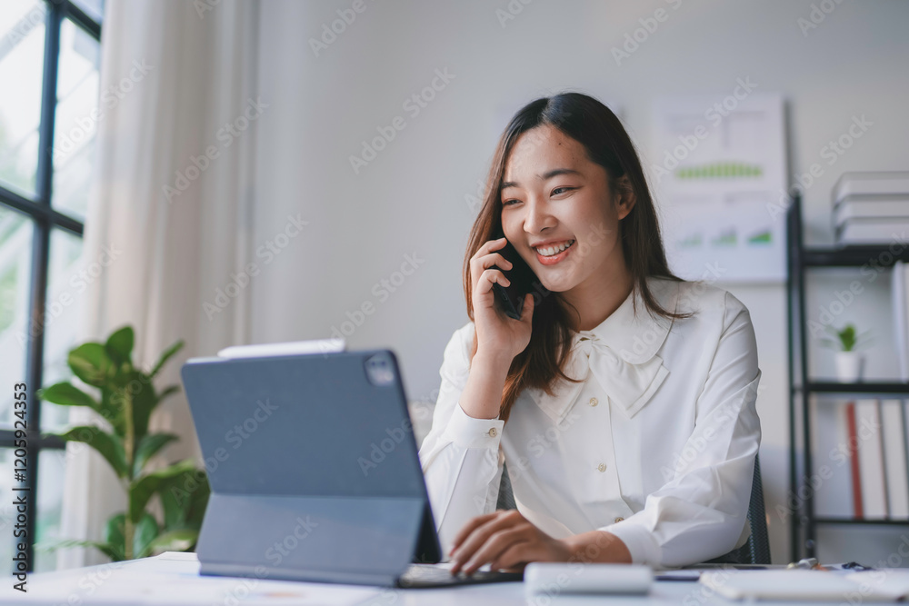 Young professional managing business communications and digital tasks, showcasing efficiency and multitasking in a contemporary workspace Young professional managing business communications and digital tasks, showcasing efficiency and multitasking in a contemporary workspace