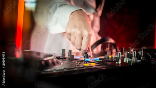 Close up DJ plays live set and mixing music on turntable console in the night club. Disc Jokey Hands on a sound mixer station at club party. DJ mixer controller panel for playing music and partying.