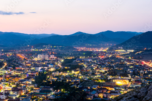 Beautiful night view of Sudak city after sunset. Southern coast of Crimea peninsula. Russia