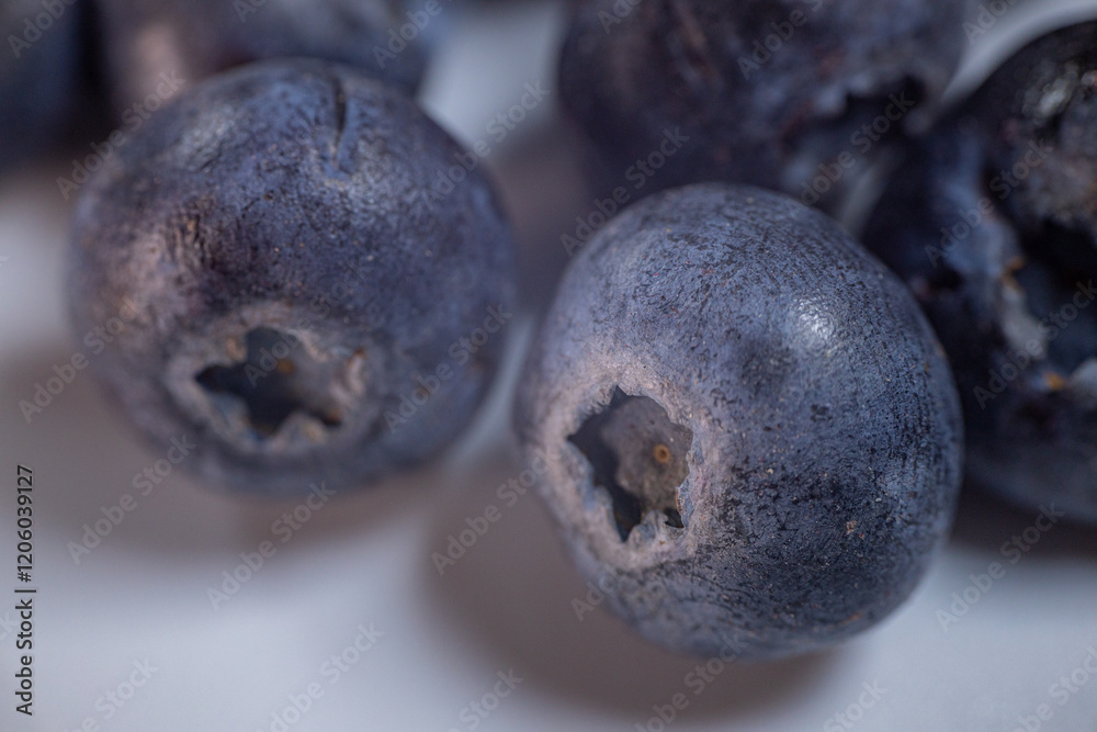 A detailed macro shot of freeze-dried blueberries, showcasing their wrinkled texture and rich blue-purple tones. Ideal for healthy food themes. A detailed macro shot of freeze-dried blueberries, showcasing their wrinkled texture and rich blue-purple tones. Ideal for healthy food themes.