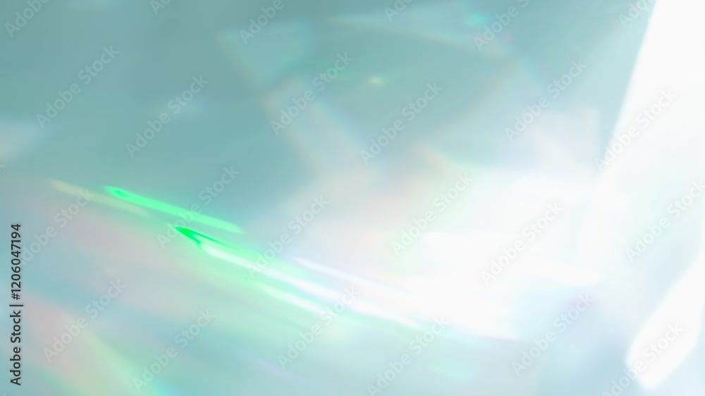 Rainbow Rays of Light in a Prism. Loop. The optical lens system creates a series of bright, changing geometric highlights on a light surface