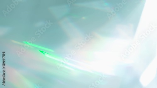 Rainbow Rays of Light in a Prism. Loop. The optical lens system creates a series of bright, changing geometric highlights on a light surface