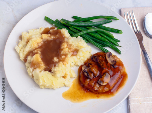 salisbury steak top with gravy, onions andmushrooms