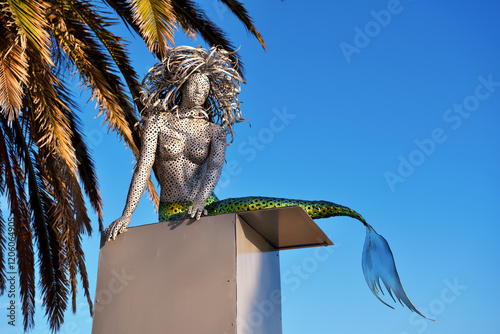 metal sculpture of a mermaid (anonymous artist) on the promenade of armacao de pera algarve portugal