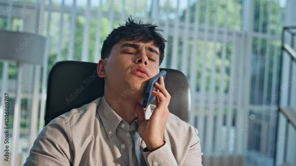 Worried manager talking smartphone hearing bad work news at workplace portrait