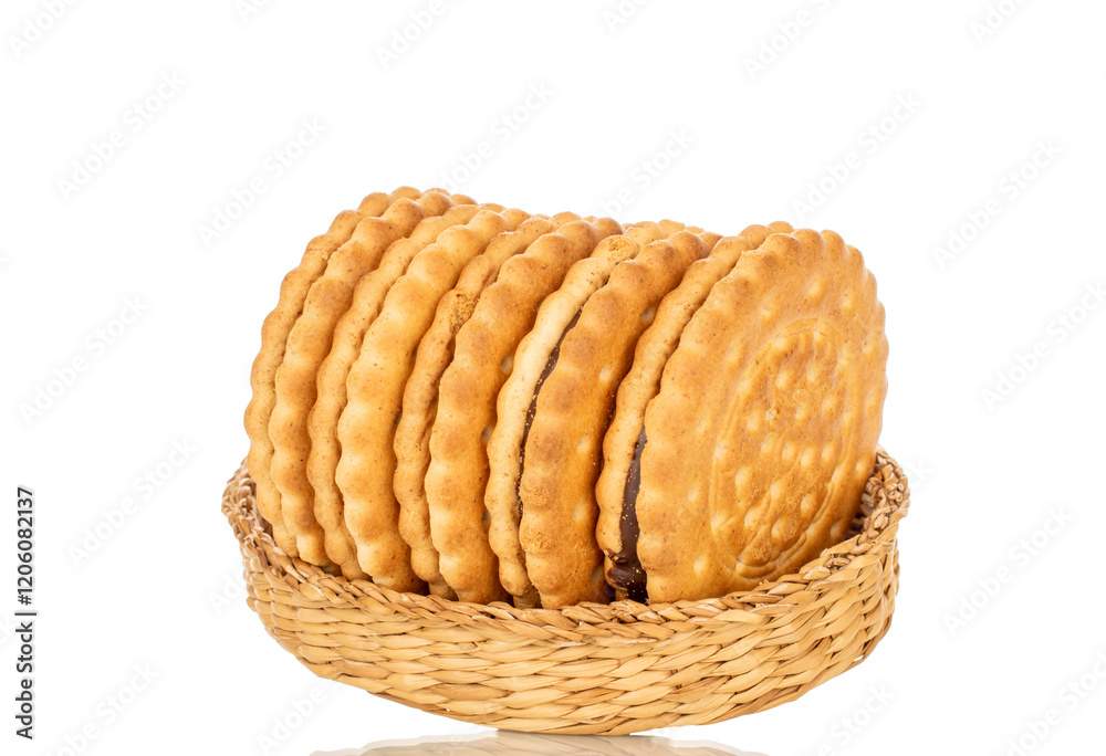 Several sweet delicious cookies in a straw plate, close-up, isolated on a white background. Several sweet delicious cookies in a straw plate, close-up, isolated on a white background.