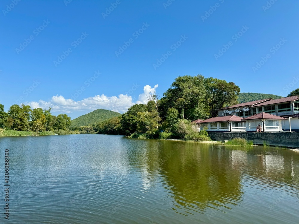 summer landscape with river and houses on the background of mountains. High quality photo summer landscape with river and houses on the background of mountains. High quality photo
