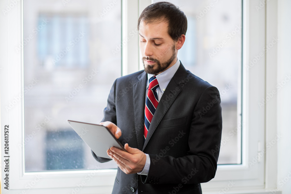 Fototapeta premium Businessman using tablet in office setting