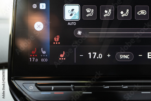 Heated seat dashboard in a car. Steering wheel heating button in the car. Switching ON heated seats of car by pressing the buttons. Electric car control panel with steering wheel and seat heating photo
