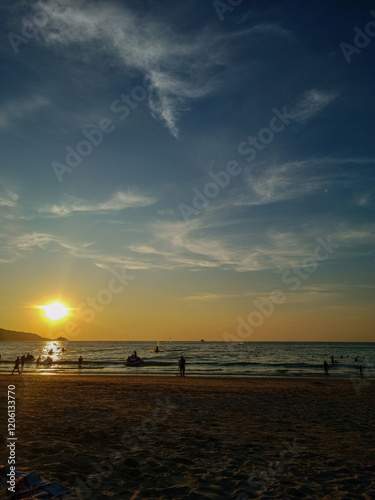 Busy beach at sunset, Phuket island, Thailand