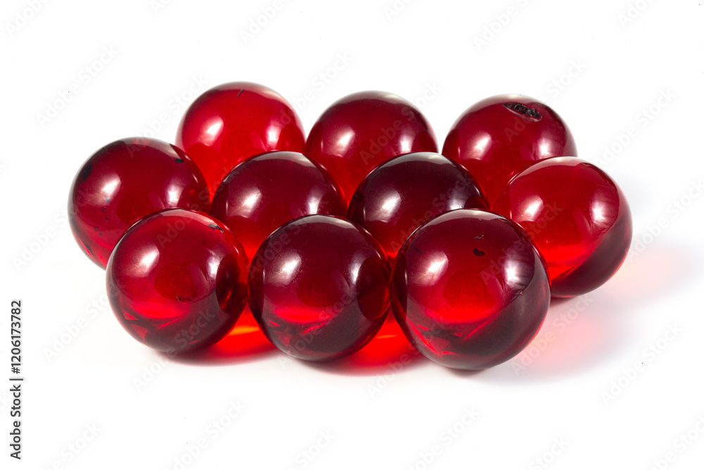 A bunch of red glass balls are sitting on a white background A bunch of red glass balls are sitting on a white background