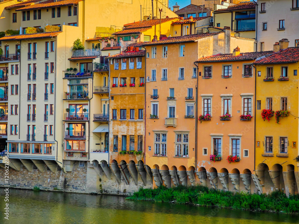 Florence, Italy. Arno river and panoramic view of Firenze old town with old building on a shore on a sunny day Florence, Italy. Arno river and panoramic view of Firenze old town with old building on a shore on a sunny day