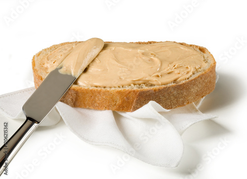 Wallpaper Mural Slice of bread with peanut butter to spread with a knife on a white background Torontodigital.ca