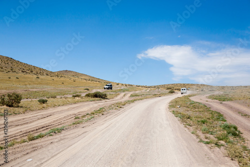 Landscape with dirt road near Ulgii city, Mongolia photo