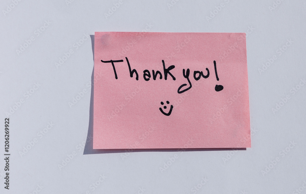 Pink sticky note with handwritten 'Thank you!' message and smiley face Pink sticky note with handwritten 'Thank you!' message and smiley face