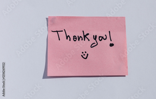 Pink sticky note with handwritten 'Thank you!' message and smiley face photo