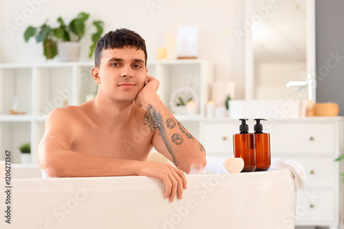 Handsome man taking bath at...