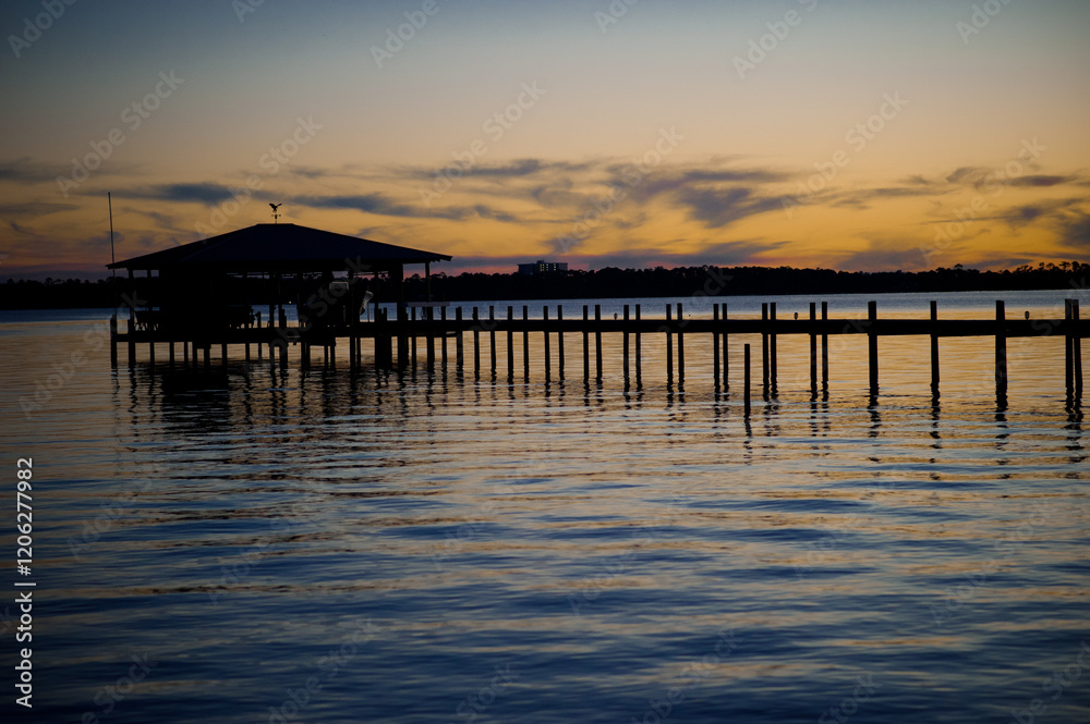 Fototapeta premium Silhouette pier at sunset in Arica Bay Alabama USA