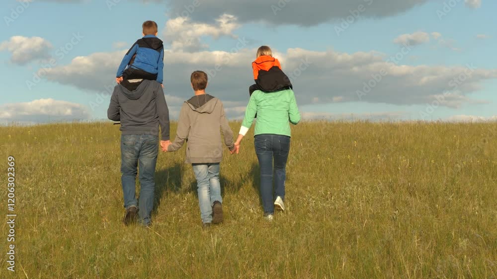 happy family holding hands walk through park against background sky with clouds. child father mother teamwork. joint family vacation trip with cheerful children. kid sons with parents weekend life day happy family holding hands walk through park against background sky with clouds. child father mother teamwork. joint family vacation trip with cheerful children. kid sons with parents weekend life day