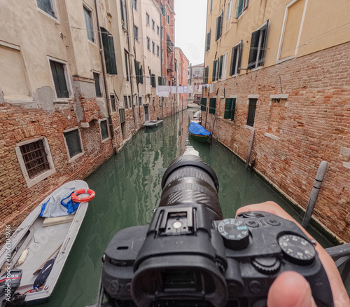 A top view of a camera filming a narrow canal in Venice. photo