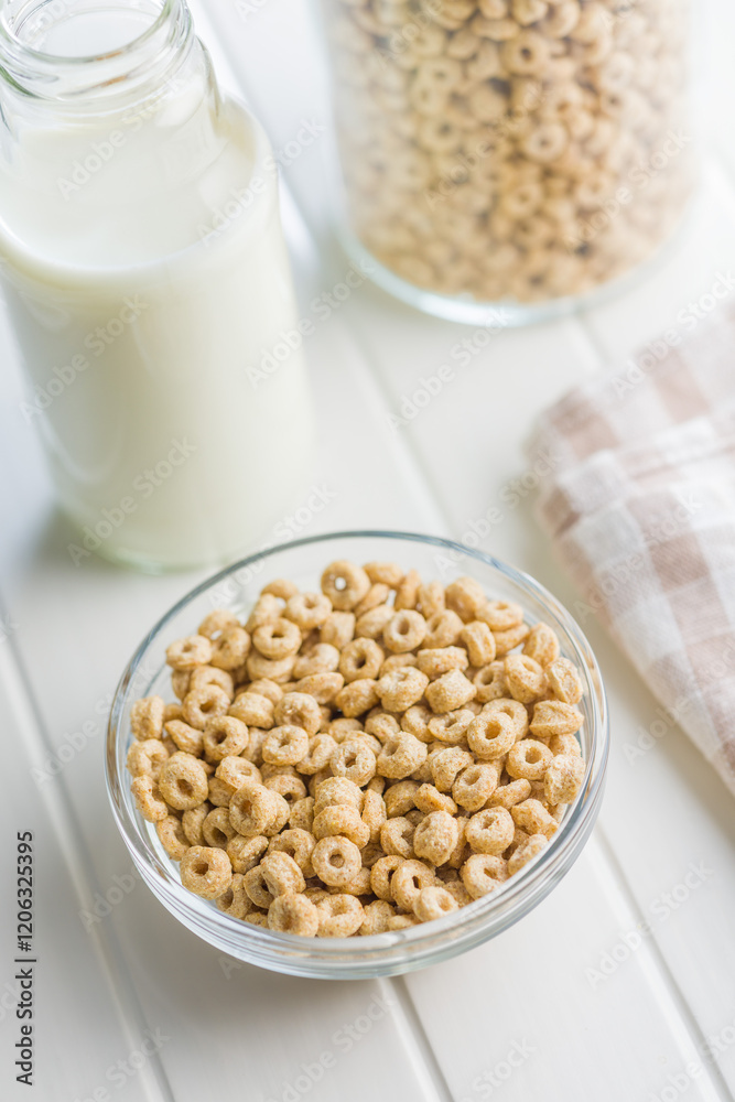Sweet honey cereal rings in bowl on white table. Sweet honey cereal rings in bowl on white table.