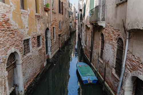 Venice. A boat parked in a quiet narrow canal. photo