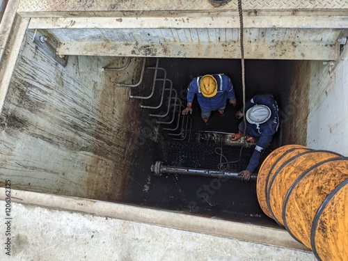 Workers Inside a Tank