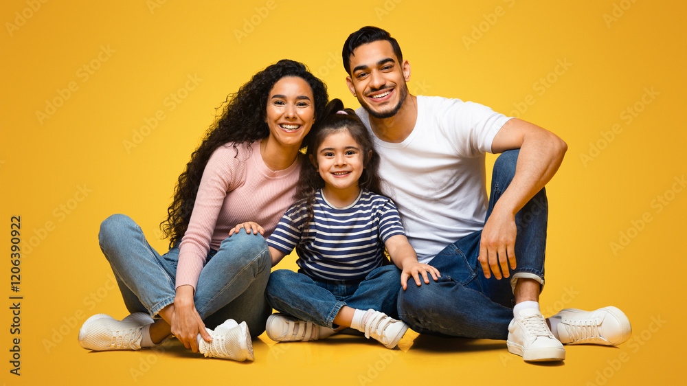 Portrait Of Smiling Arab Parents And Little Daughter Posing Together Over Yellow Background, Happy Young Middle Eastern Family Of Three Bonding While Sitting On Floor In Studio, Closeup Shot Portrait Of Smiling Arab Parents And Little Daughter Posing Together Over Yellow Background, Happy Young Middle Eastern Family Of Three Bonding While Sitting On Floor In Studio, Closeup Shot