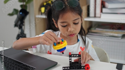 STEM education concept. Asian home school girls self-study online lessons and are excited to make STEM toys. mathematics engineering science technology computer code in robotics for kids' concepts. photo