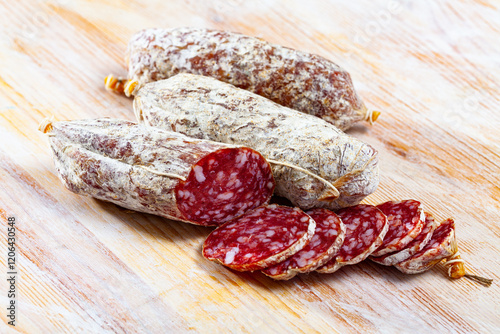 Italian cacciatori salami sausages on a wooden table. High quality photo