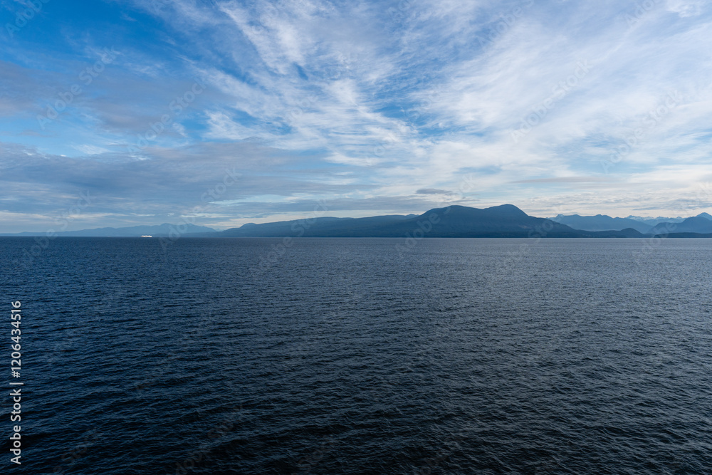 clouds over Strait of Georgia blue sky water landscape mountains on the horizon British Columbia Canada clouds over Strait of Georgia blue sky water landscape mountains on the horizon British Columbia Canada
