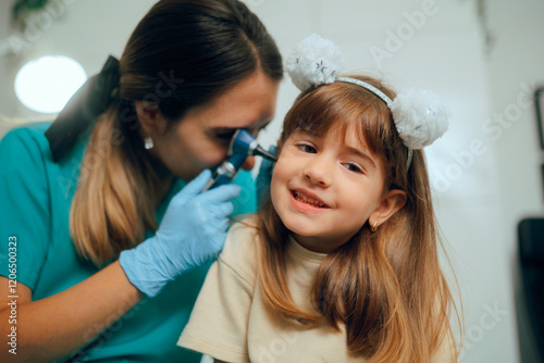 ENT Doctor Checking the Ear of a Child with Otoscope. Little kid having problems with otitis after a flu episode
