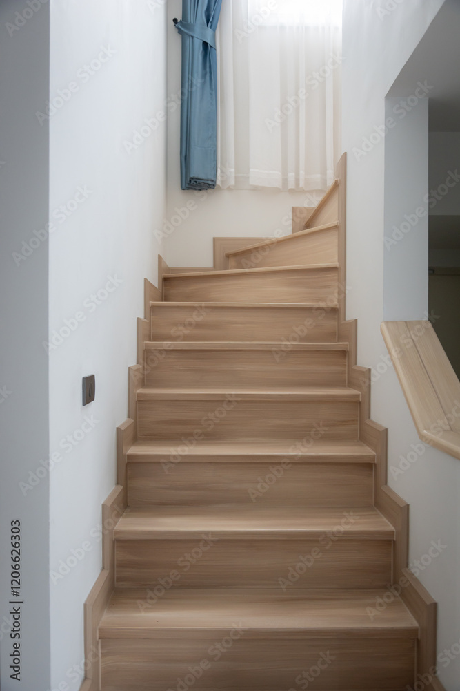 Fototapeta premium A modern, light-toned wooden staircase inside a contemporary home
