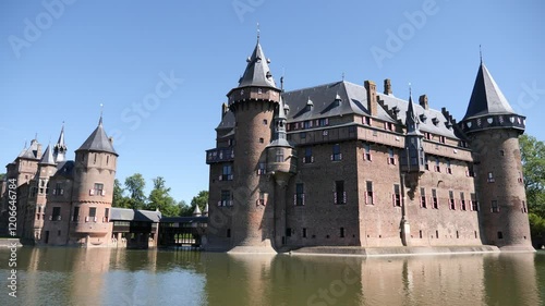 De Haar Castle from outside during daytime under clear deep blue sky. Utrecht, Netherlands.  photo