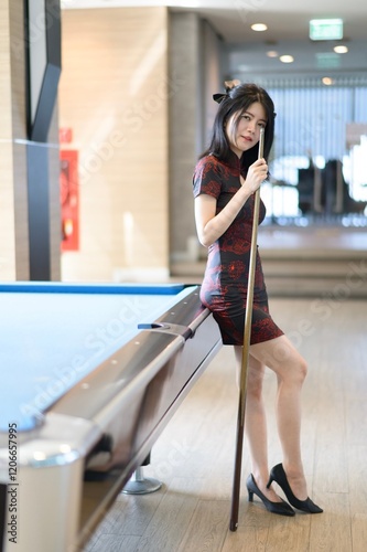 Asian woman wearing traditional cheongsam dress. Portrait of female model. Happy Chinese New Year.