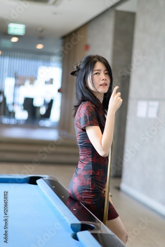 Girl wearing traditional cheongsam dress. Portrait of female model. Happy Chinese New Year.