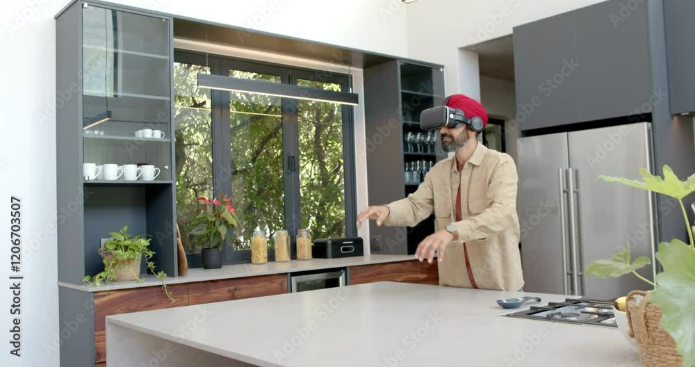 Using VR headset, man exploring virtual reality in modern kitchen at home Using VR headset, man exploring virtual reality in modern kitchen at home