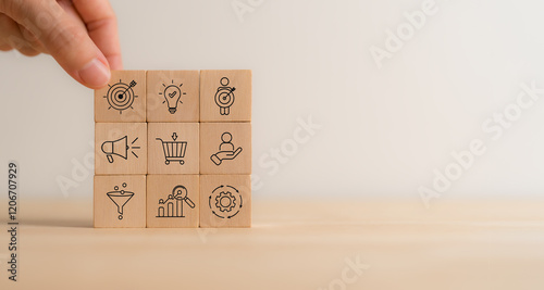 Marketing and business strategy, goals and achievement concept. Wooden blocks featuring icons related to marketing, business strategies, customer targeting and analytics. Marketing management. photo