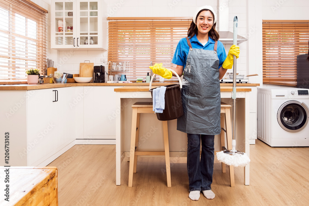 A cheerful person stands in a bright kitchen holding cleaning supplies, ready to tackle household chores with a smile. Professional cleaner and chore service concept. Cleaner small business concept. A cheerful person stands in a bright kitchen holding cleaning supplies, ready to tackle household chores with a smile. Professional cleaner and chore service concept. Cleaner small business concept.