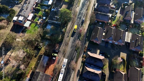 Aerial top down shot of neighborhood with driving bus and DHL Delivery Truck in winter season. Sunny day in german town. Flyover shot.
