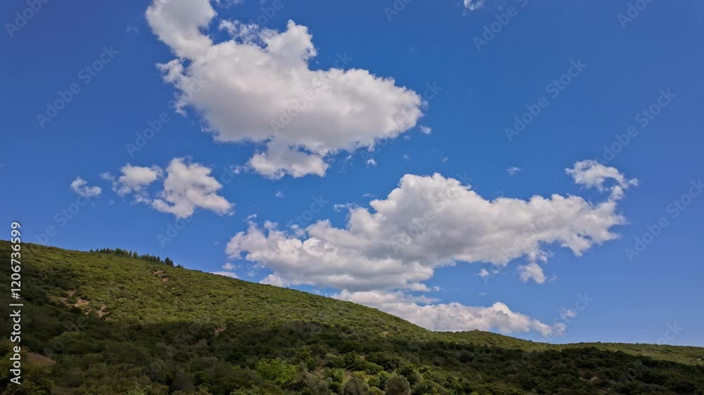 Cumulus dense clouds over light blue sky travelling Crete island Greece land Cumulus dense clouds over light blue sky travelling Crete island Greece land