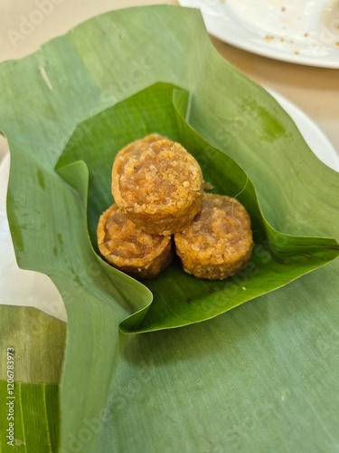 Traditional Thai sweet filling dessert wrapped with banana leaves. Famous ancient coconut snack in Asia restaurant.