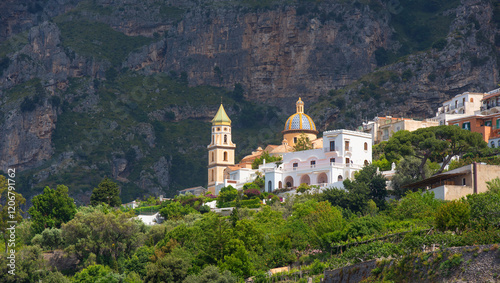 A picturesque village with a Catholic cathedral on the side of a mountain in Italy on the Amalfi Coast