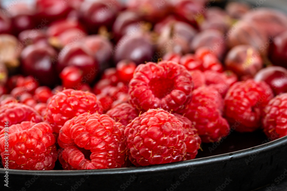 Tasty fresh ripe raspberry, red currant, gooseberry. Nutrients, Healthy berry texture on dark background. Red summer berries on black plate, food photography for food blog Tasty fresh ripe raspberry, red currant, gooseberry. Nutrients, Healthy berry texture on dark background. Red summer berries on black plate, food photography for food blog