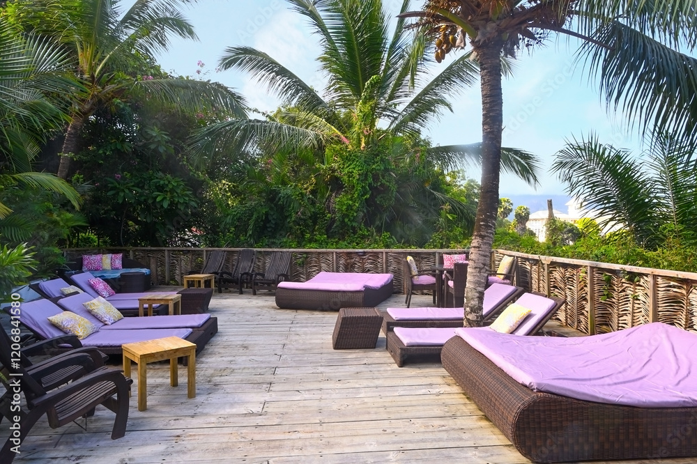 Fototapeta premium Relaxation area with sun beds in a tropical resort