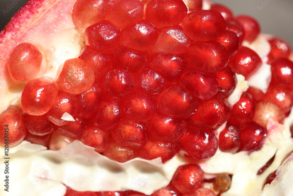 Open pomegranate displaying its seeds Open pomegranate displaying its seeds