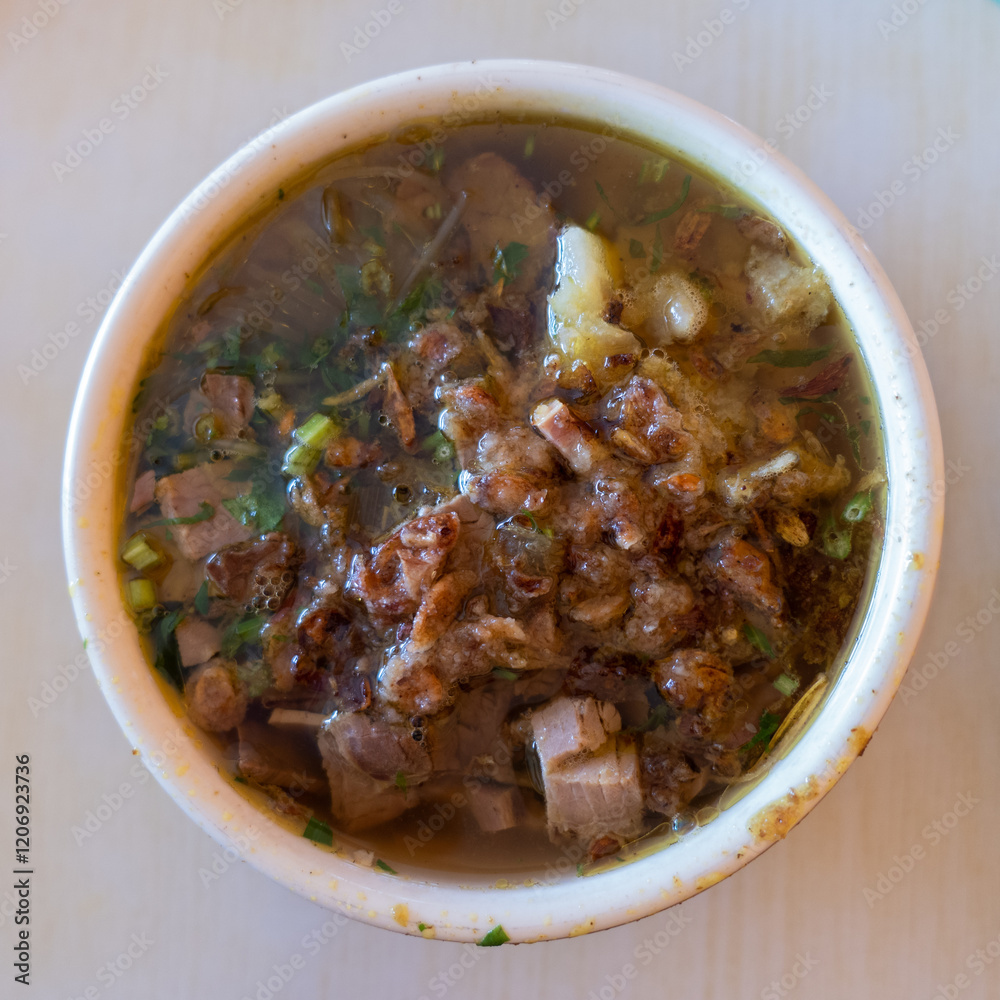 Traditional Indonesian beef soup, as well known as Soto. Indonesian Traditional Meat Soup Bowl with Flavorful Garnishes. Traditional Indonesian beef soup, as well known as Soto. Indonesian Traditional Meat Soup Bowl with Flavorful Garnishes.