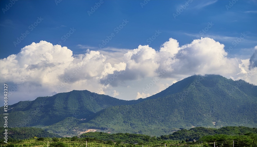 Fototapeta premium The countryside flourishes under the watchful clouds. 